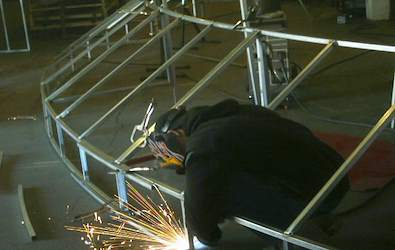Custom awning frame being welded in the fabrication shop